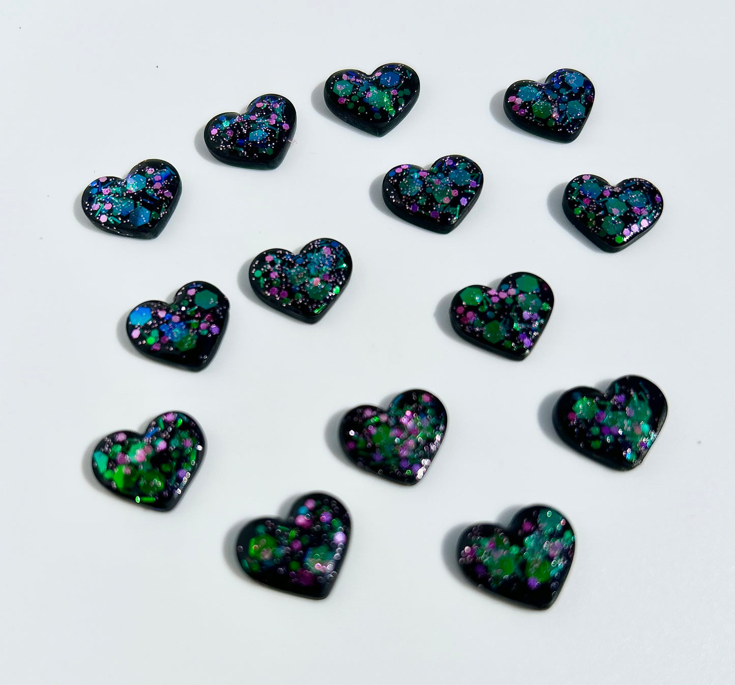 Black hearts with pink and green sparkles